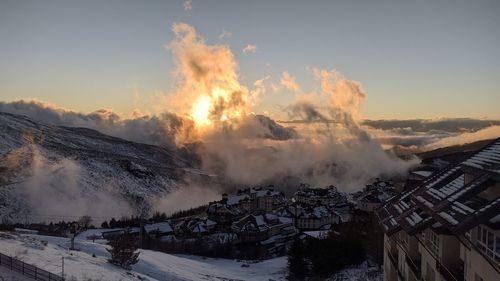 Panoramic view of snowcapped mountains against sky during sunset