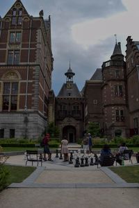 People in front of buildings against sky