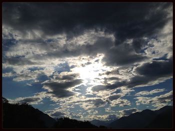 Scenic view of mountains against cloudy sky