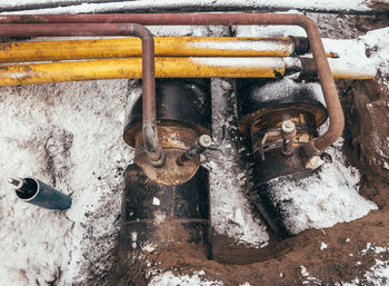High angle view of rusty machine part on snow