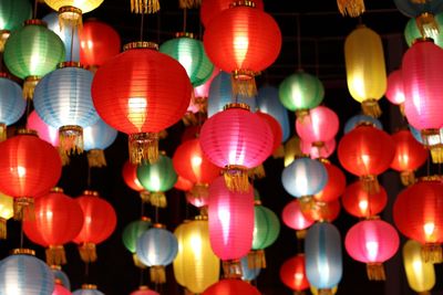 Low angle view of illuminated lanterns hanging at night