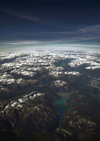 High angle view of snowcapped mountains against sky