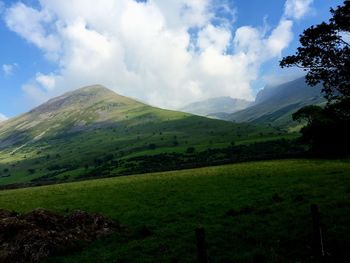 Scenic view of mountains against cloudy sky