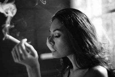 Close-up of young woman smoking