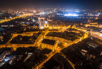 Aerial view of illuminated cityscape against sky at night