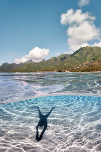 Man swimming in pool against sea