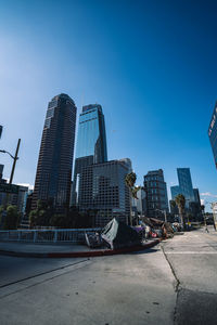 View of modern buildings against clear blue sky