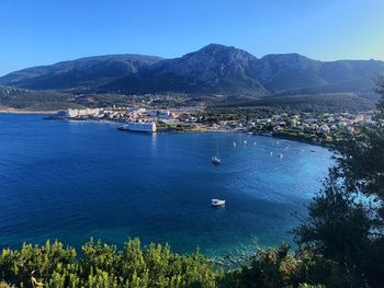 Scenic view of sea and townscape against sky