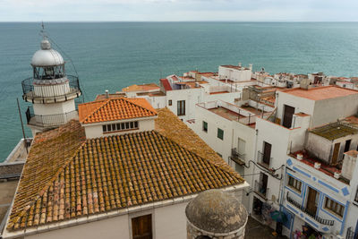 High angle view of buildings by sea