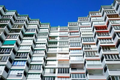 Low angle view of buildings against blue sky