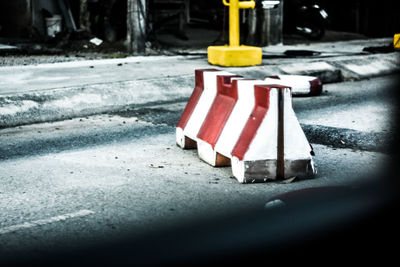 Road sign on sidewalk by street