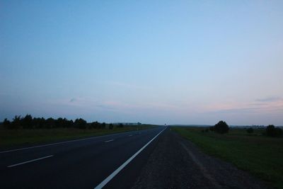 Empty road along countryside landscape