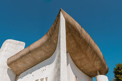 Low angle view of sculpture against blue sky