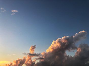 Low angle view of smoke emitting from chimney against sky