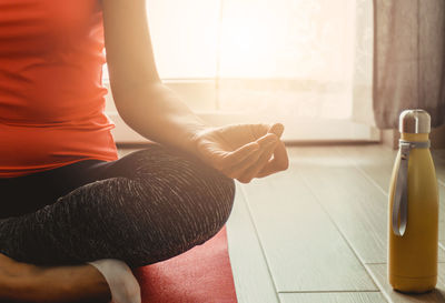Low section of woman sitting at home