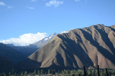 Scenic view of mountains against cloudy sky