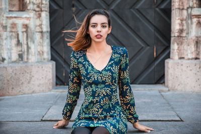 Portrait of beautiful woman sitting outdoors