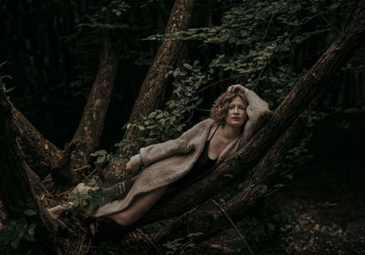 Portrait of woman relaxing on tree