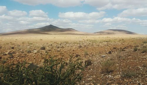 Scenic view of arid landscape against sky