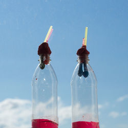 Close-up of wine bottles against blue background