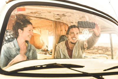 Smiling couple sitting in car