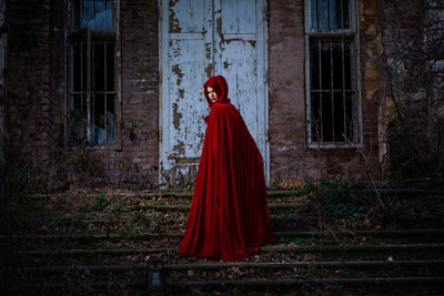 Woman standing by building