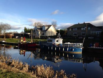 Boats in canal along buildings