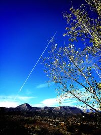 Low angle view of mountain against blue sky