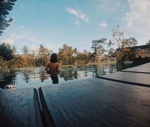 Sensuous woman in swimming pool at hotel