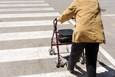 Rear view of man walking on road