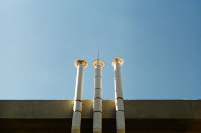 Low angle view of smoke stack against clear sky