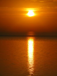 Scenic view of sea against romantic sky at sunset