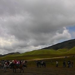 Scenic view of landscape against cloudy sky