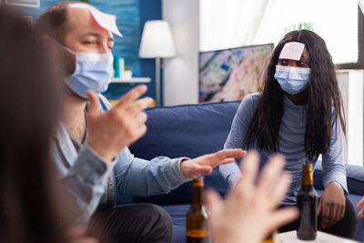 People wearing mask enjoying at home