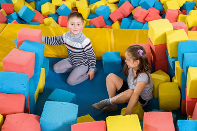 Rear view of people sitting with toy