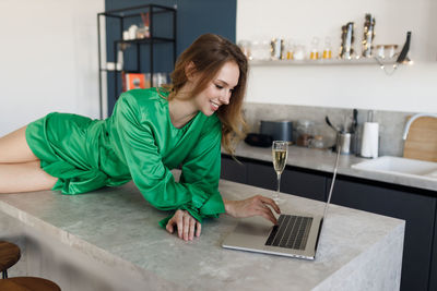 Young woman using laptop at home