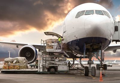 Airplane on runway against sky