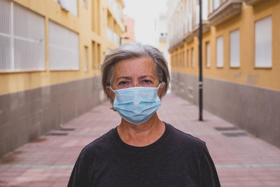 Portrait of man standing in city