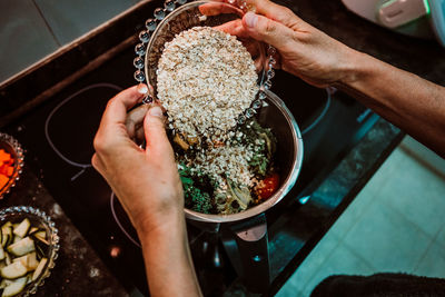 Midsection of person preparing food in kitchen