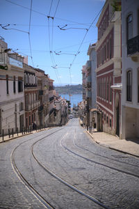 Street amidst buildings in city against sky