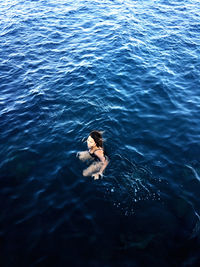 High angle view of woman swimming in sea