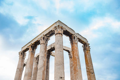 Low angle view of old building against cloudy sky in athens greece