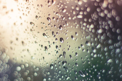 Full frame shot of raindrops on glass window