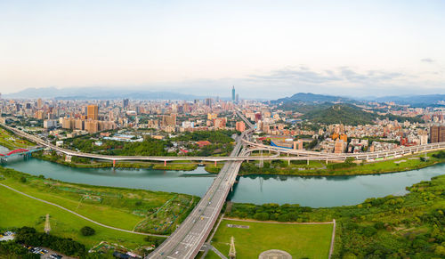 High angle view of bridge and buildings in city against sky