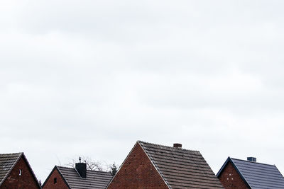 Cropped image of houses against clear sky