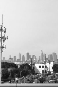 Buildings in city against clear sky