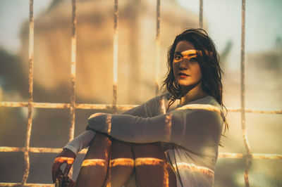 Portrait of young woman looking away outdoors