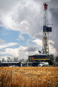 Crane on field against sky