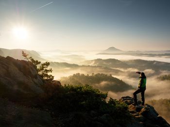 Man standing on mountain against sky