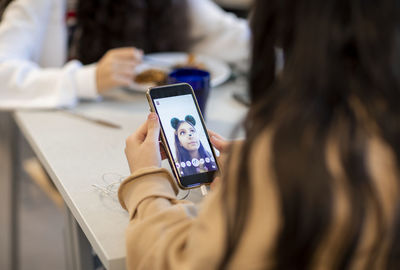 Girl looking at photo on her phone